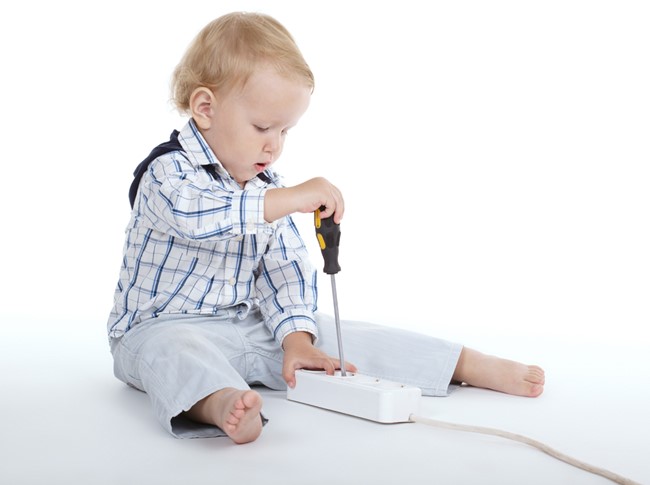 Child playing with an electrical device