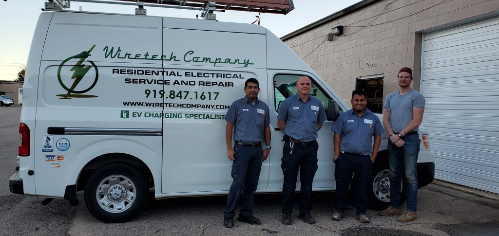 Wiretech Company team photo in front of one of our vans at our office in Raleigh, North Carolina